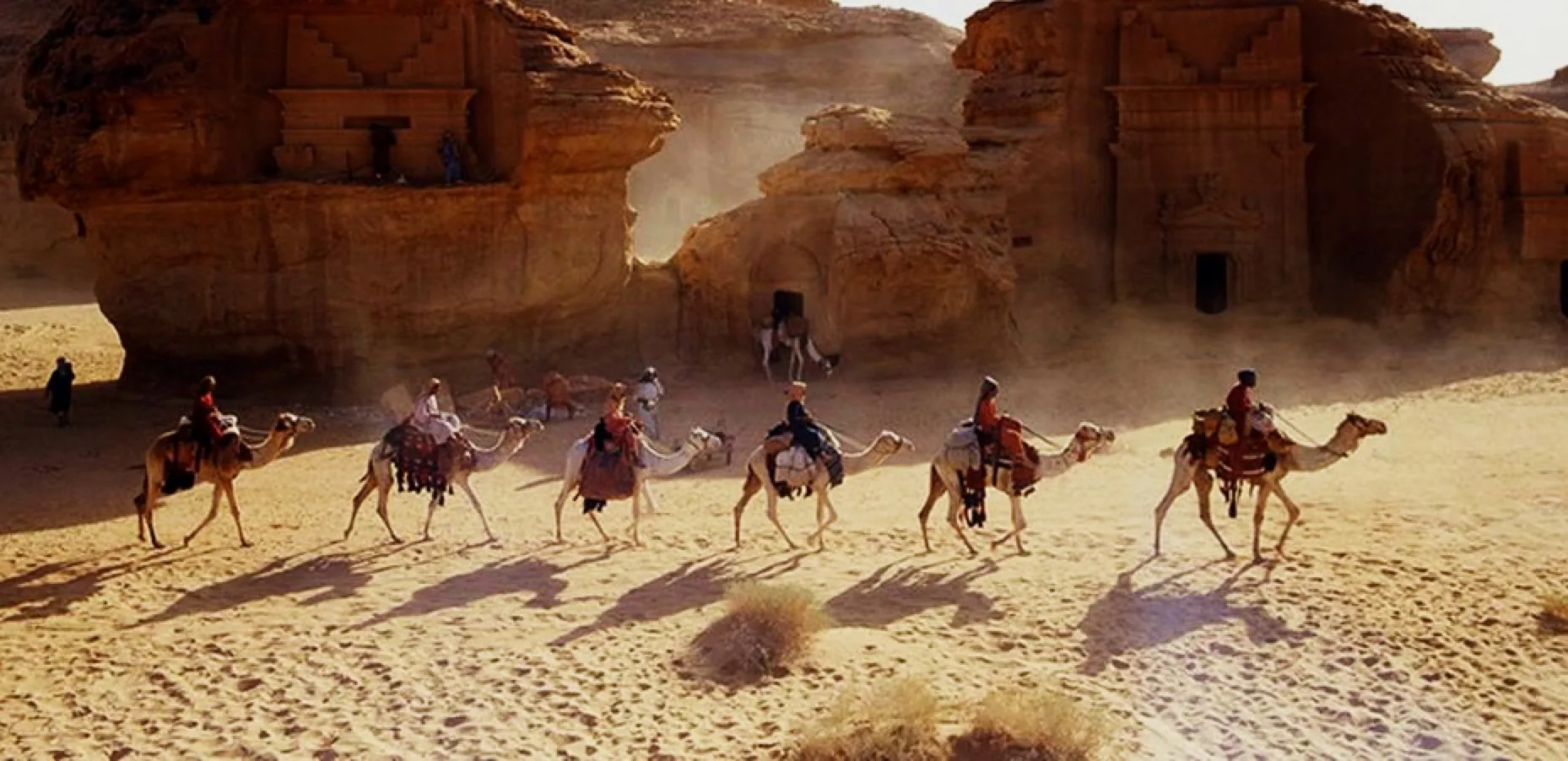 Camel caravan through ancient rock-cut tombs